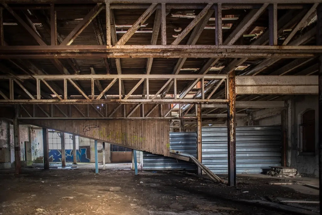 Exposed wooden rafters and framing inside an attic