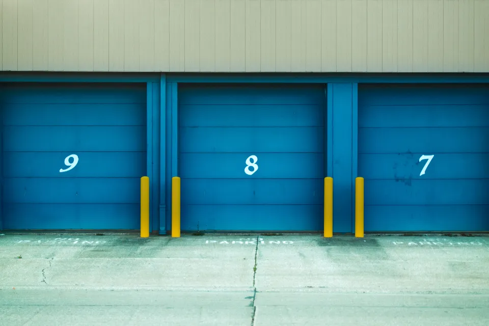 Row of numbered blue garage doors