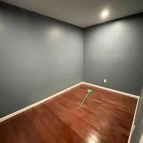 Bedroom with fresh grey paint and a new hardwood floor