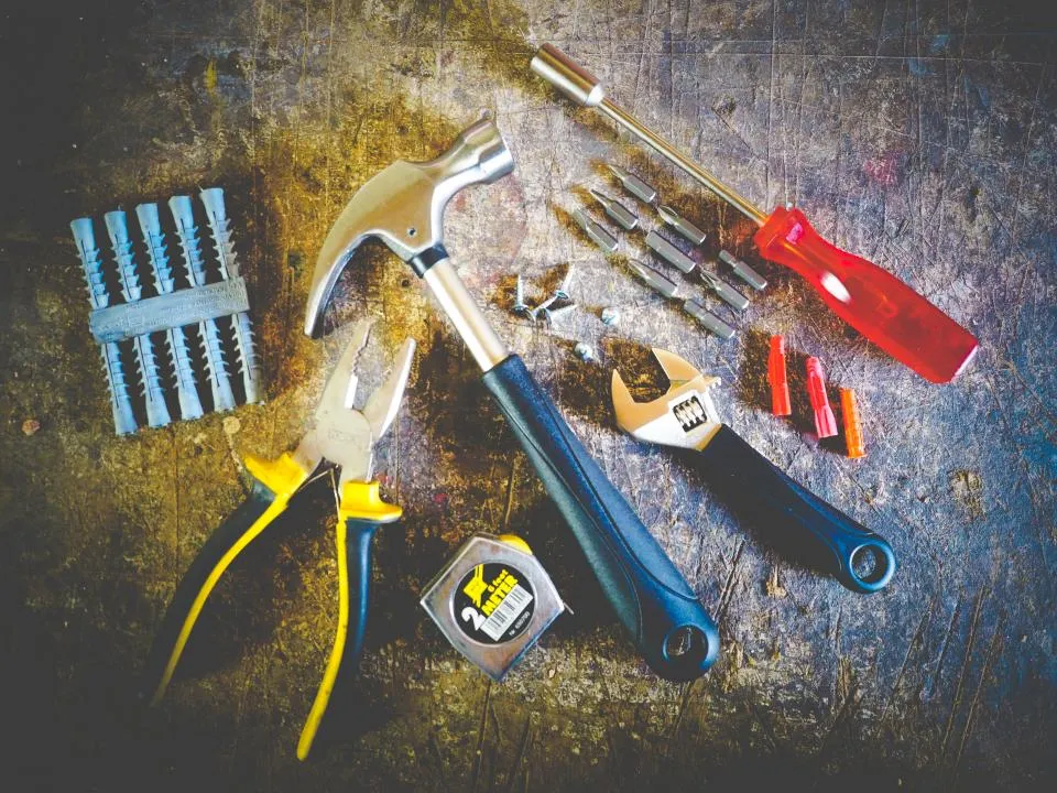 Pliers, screwdrivers and hand tools laid out for a repair