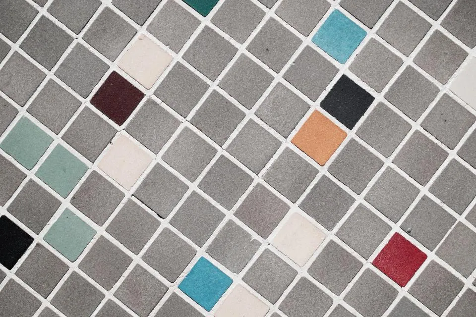 Grey square mosaic tiles with colorful accent tiles