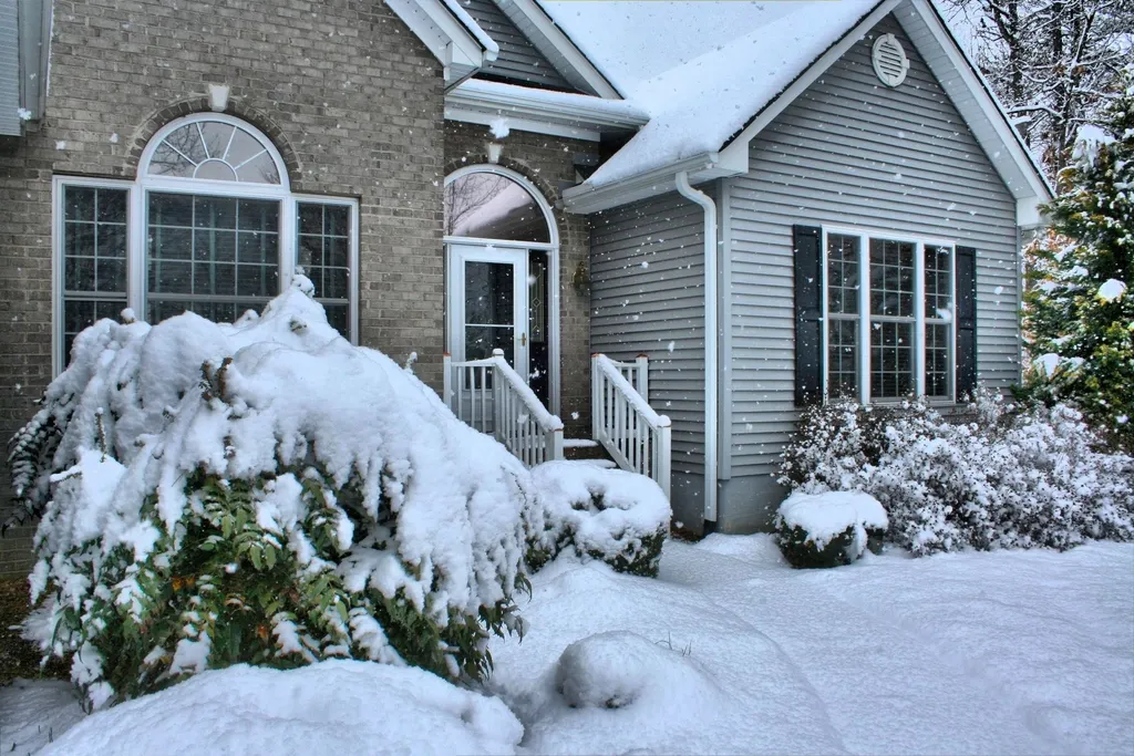 Suburban house with arched windows covered in fresh snow